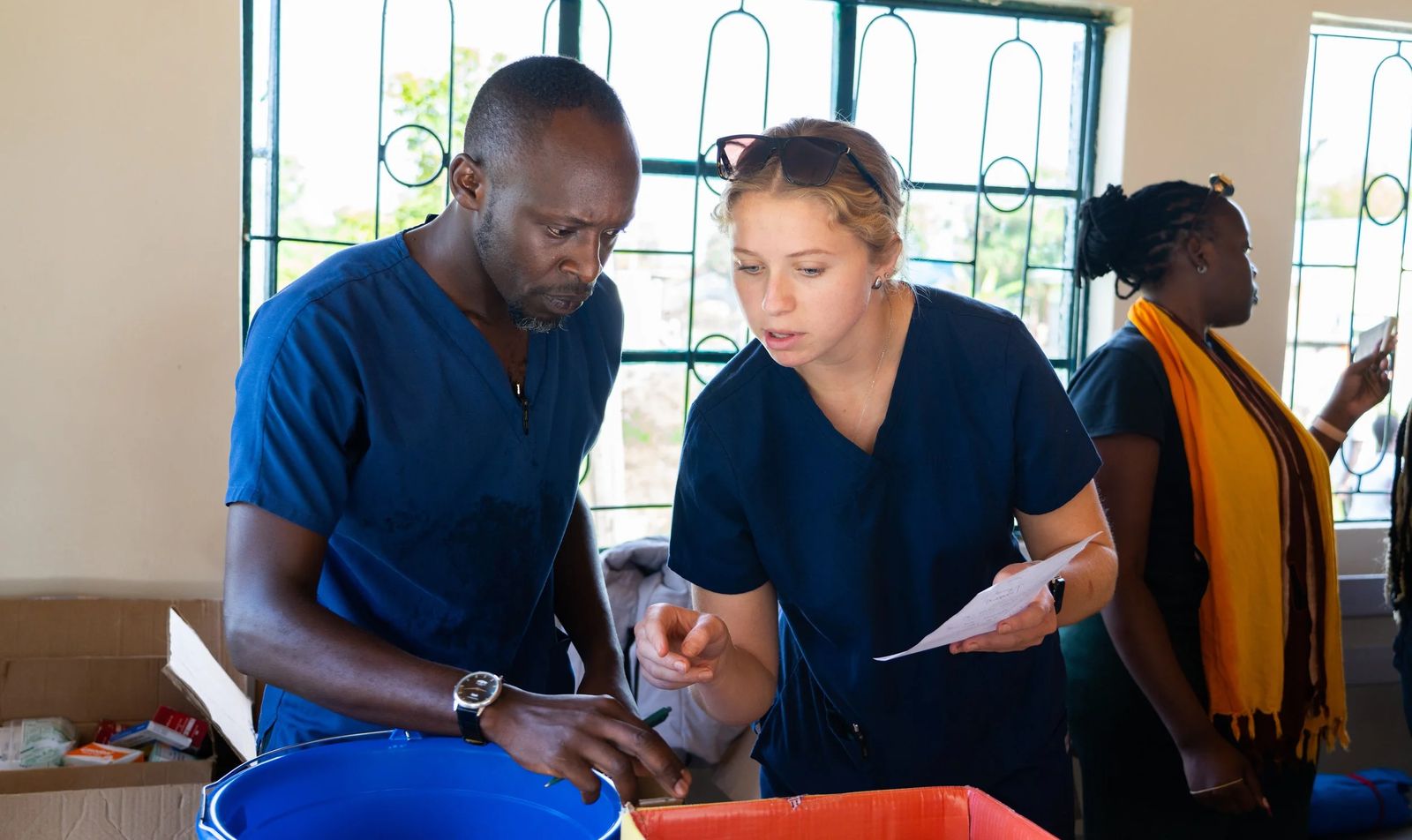 Nursing students working alongside a caregiver in Kenya