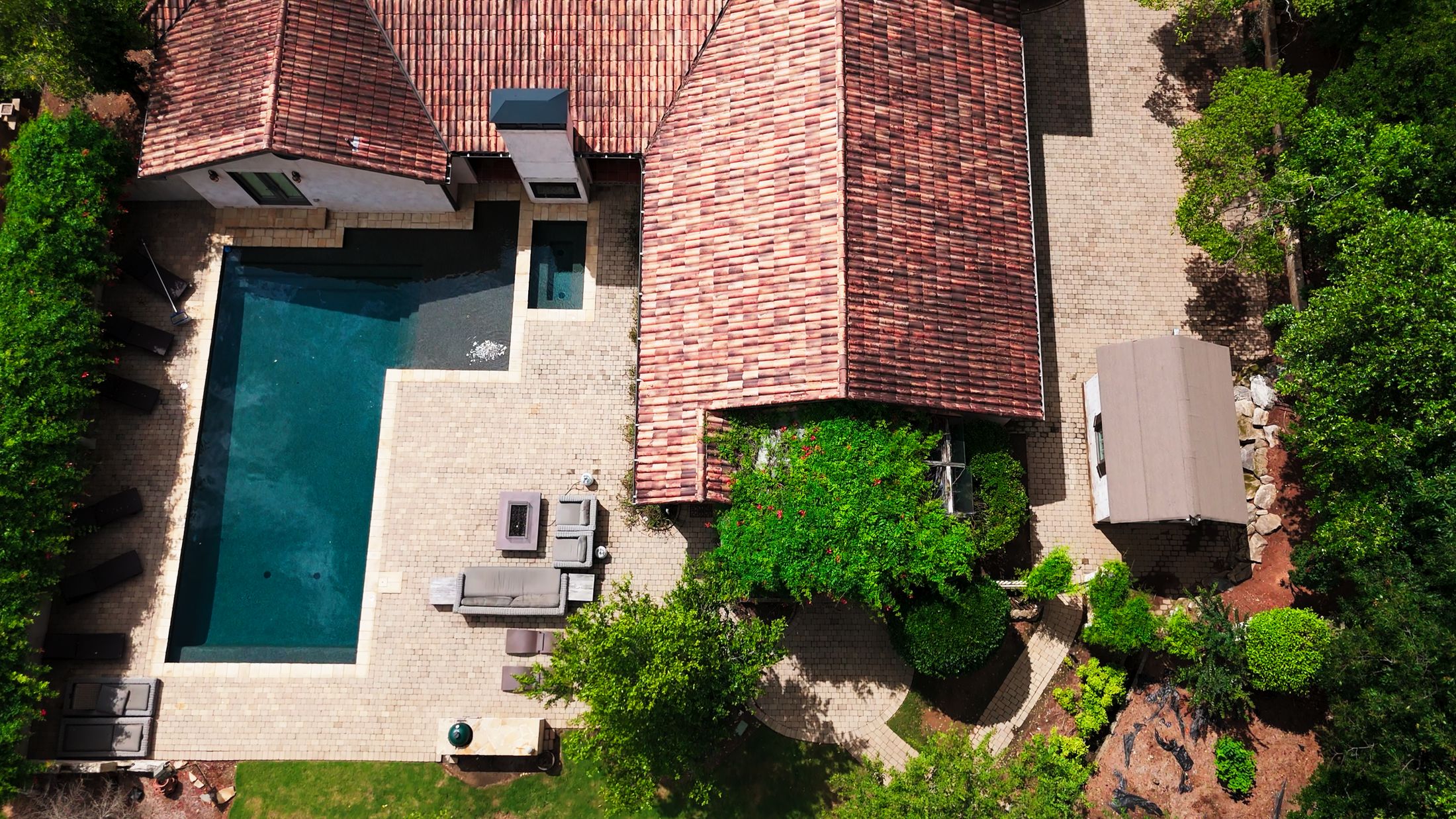 An aerial view of a home and pool