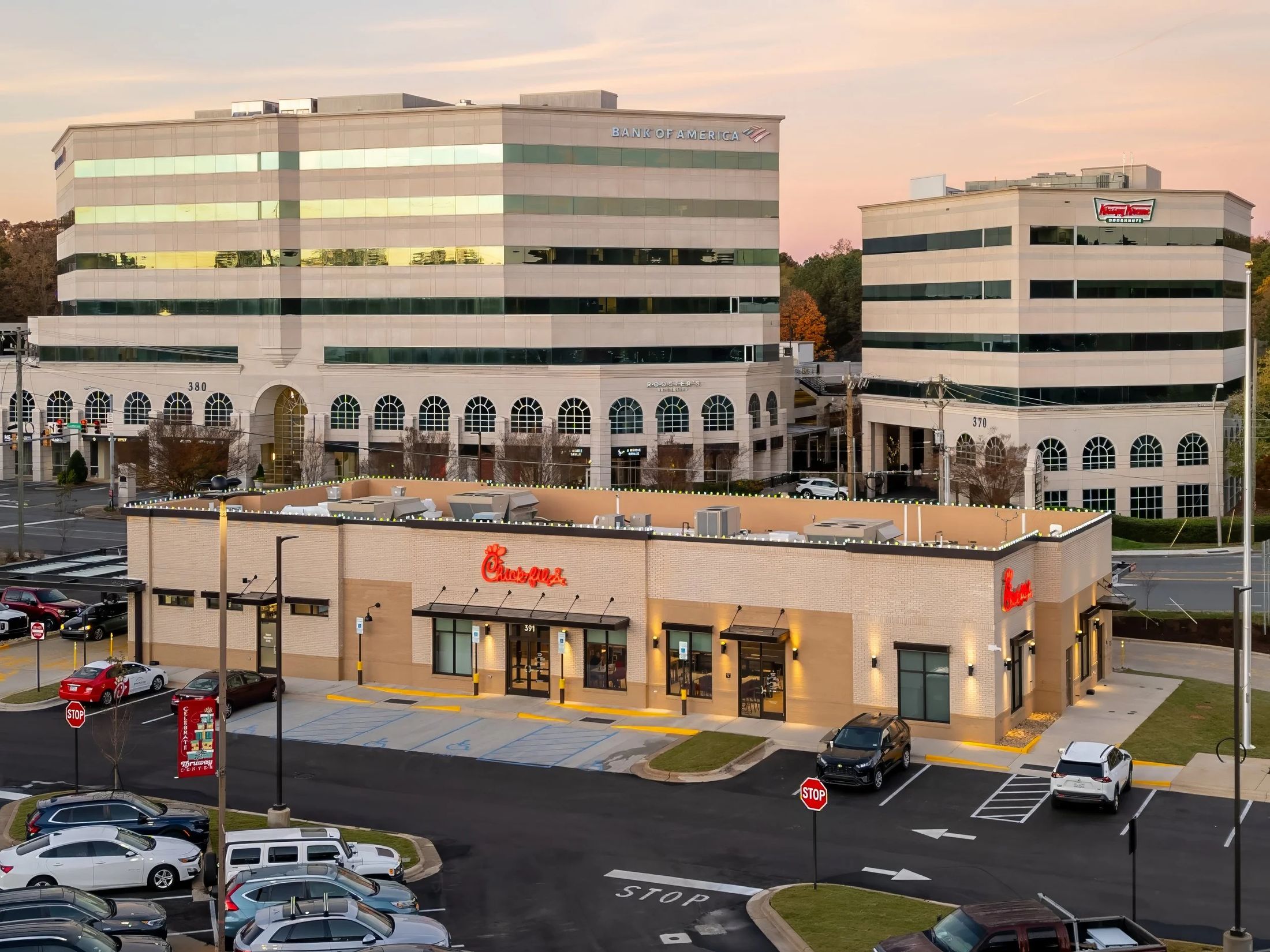 An aerial golden-hour view of a commercial property and office park
