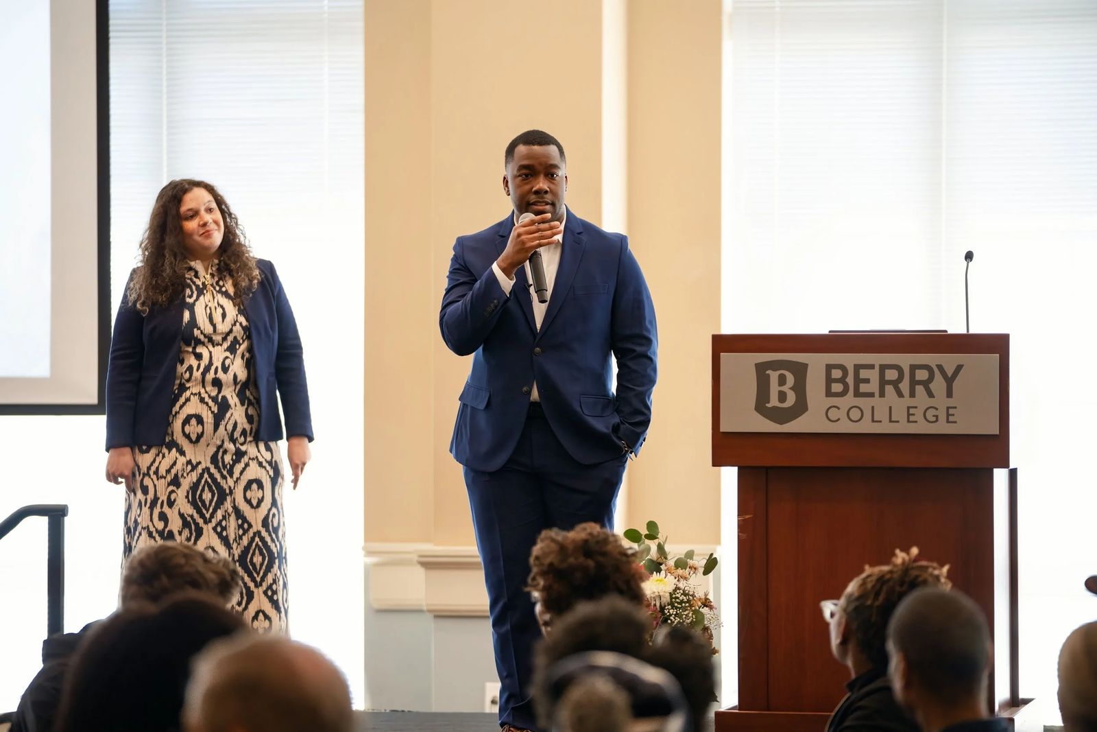 Two speakers presenting at an event