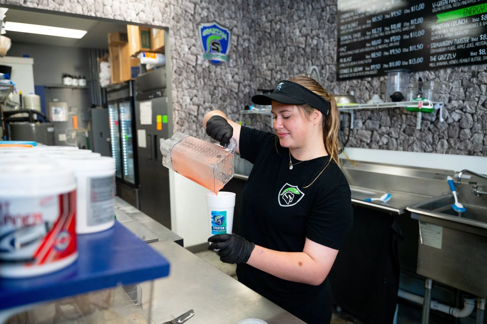 A Spartan Smoothies team member blending a drink